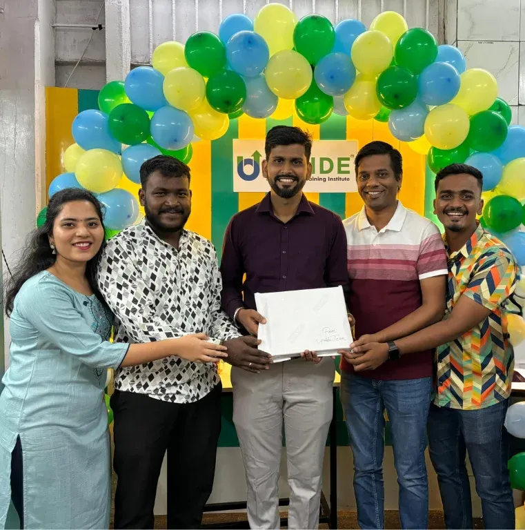 Upside mentors presenting a course certificate to a student at the institute